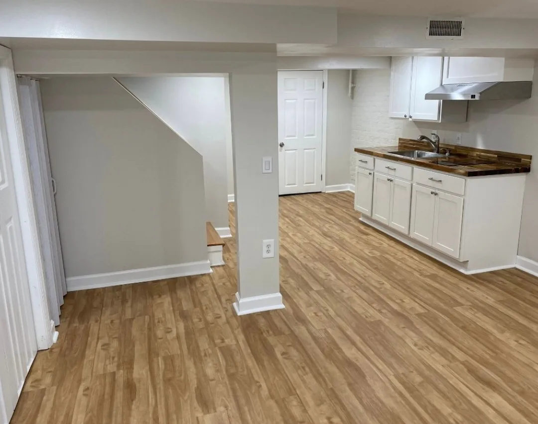 Basement finishing with kitchenette and modern flooring