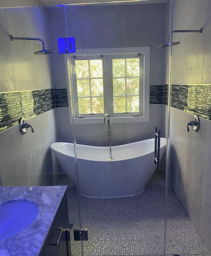 Spa bathroom with freestanding tub and dual rain showers