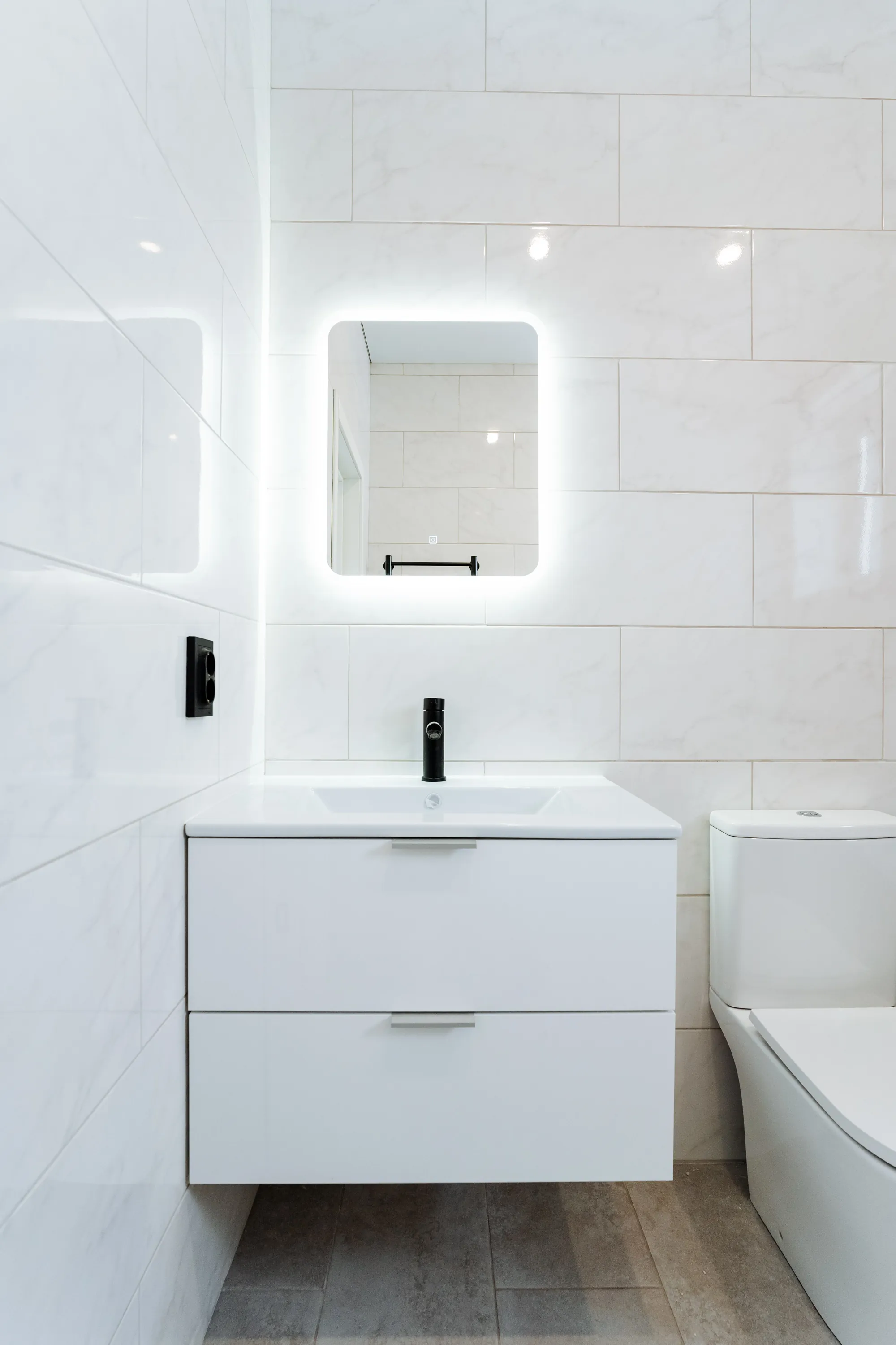 Modern bathroom with floating vanity and LED mirror