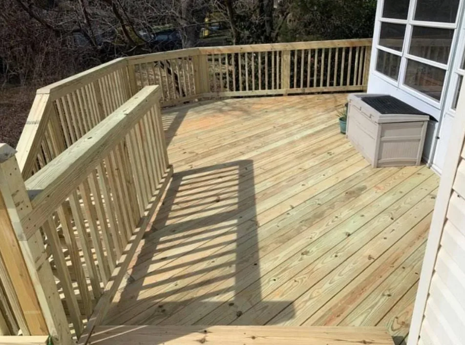 Curved wood deck with matching railing and built-in storage bench