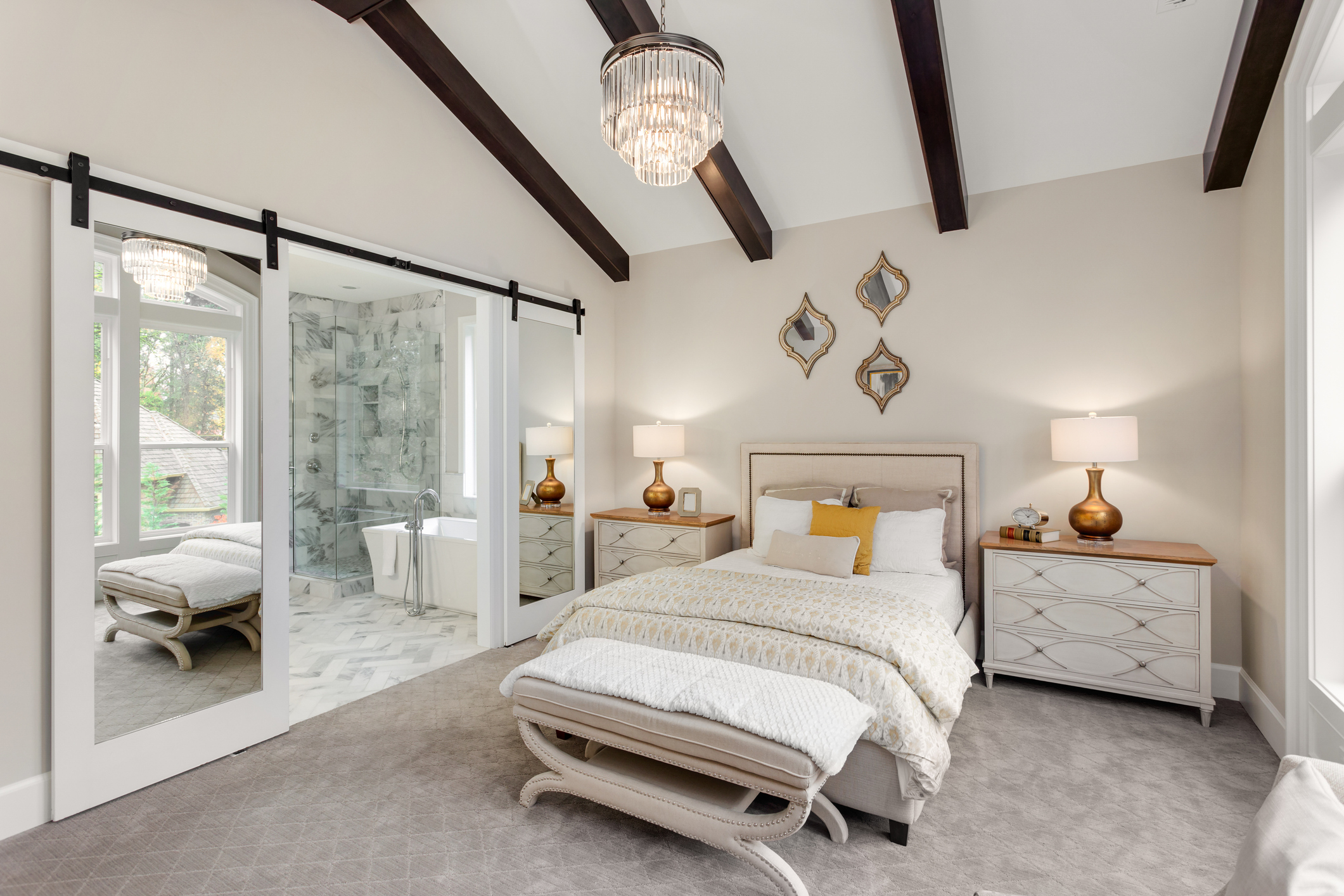 Master bedroom suite with barn doors and vaulted ceiling