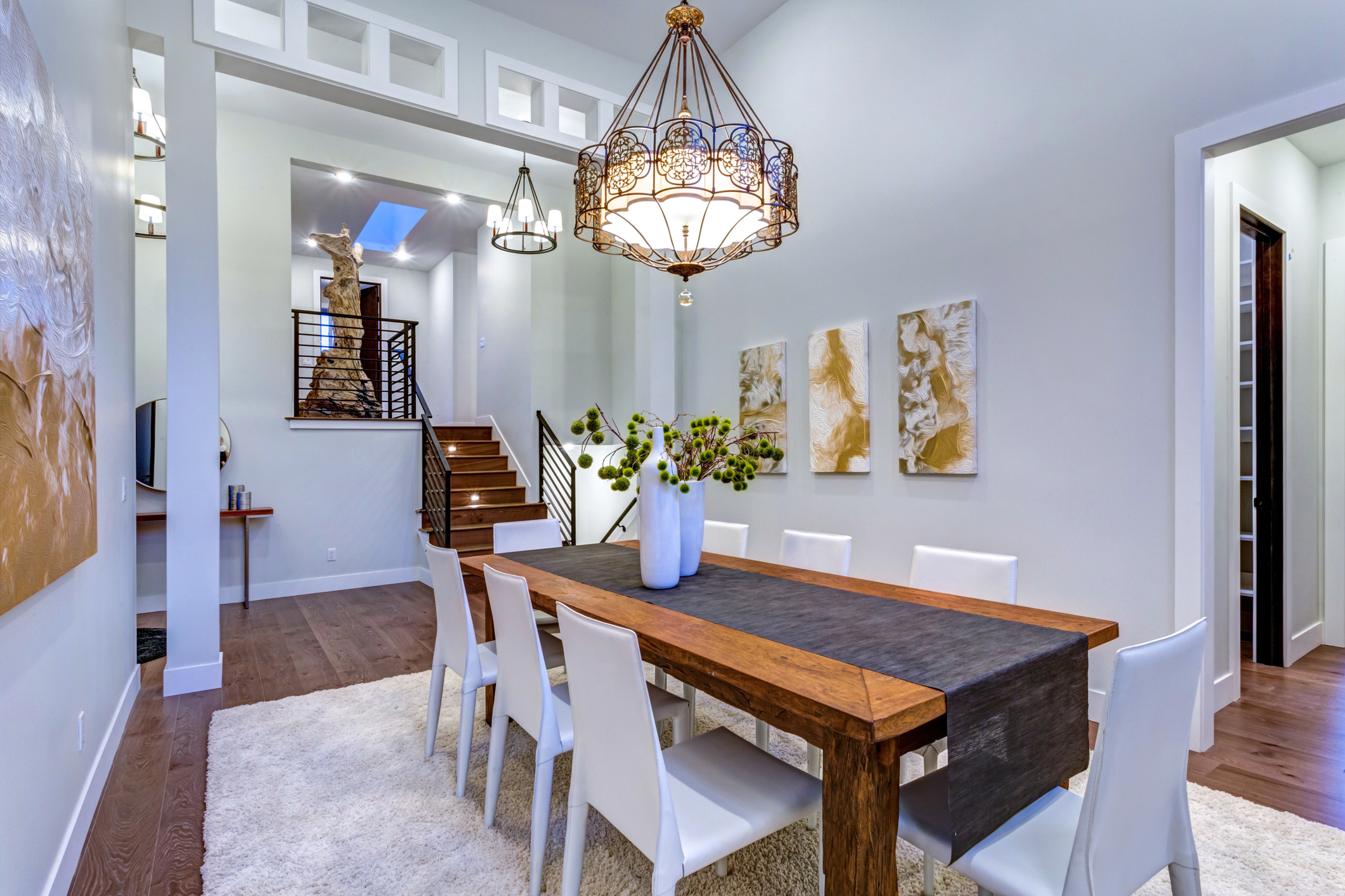 Dining room remodel with statement chandelier and wood table