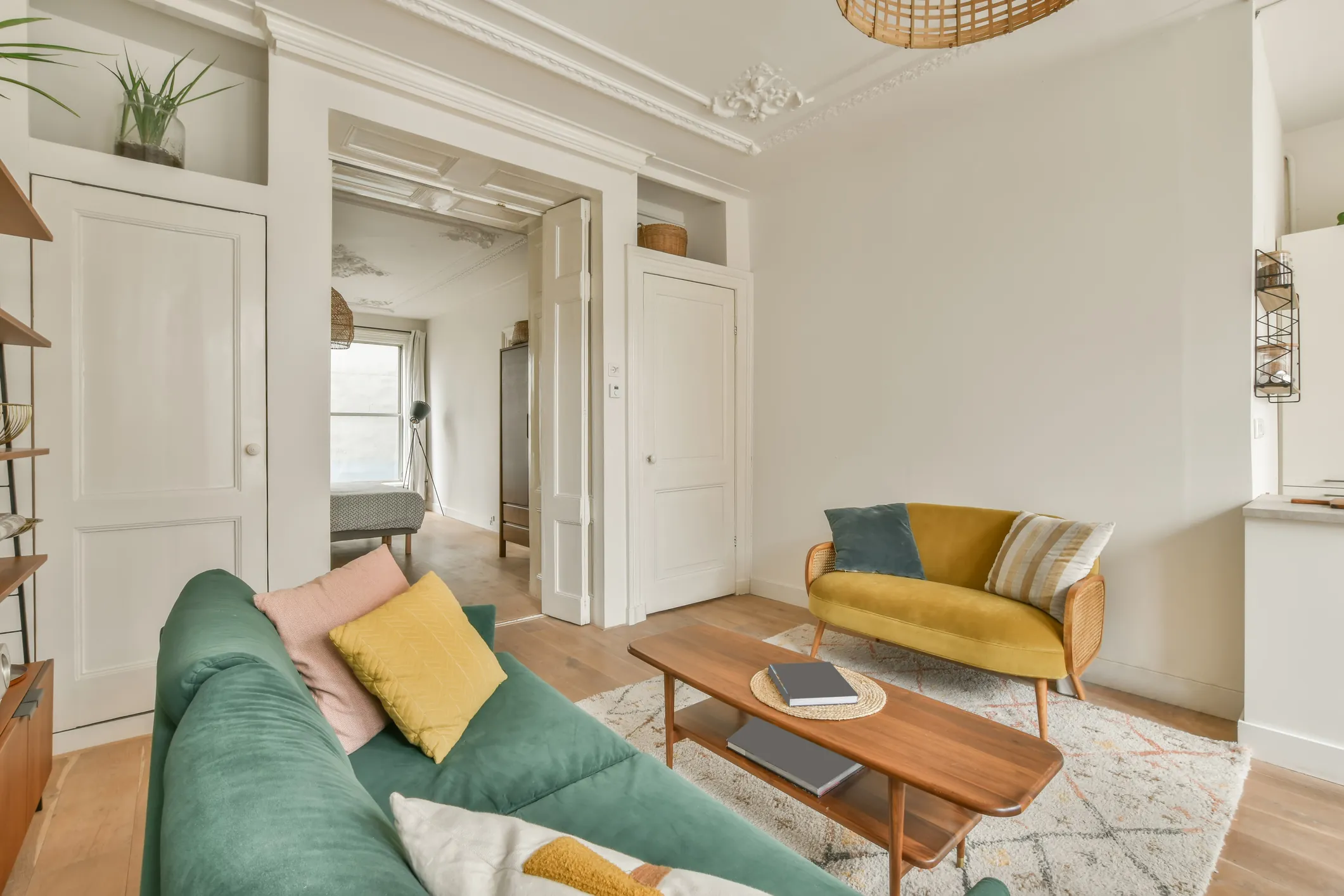 Living room opening through a wide doorway to rooms in a line beyond, with light borrowed from the far end