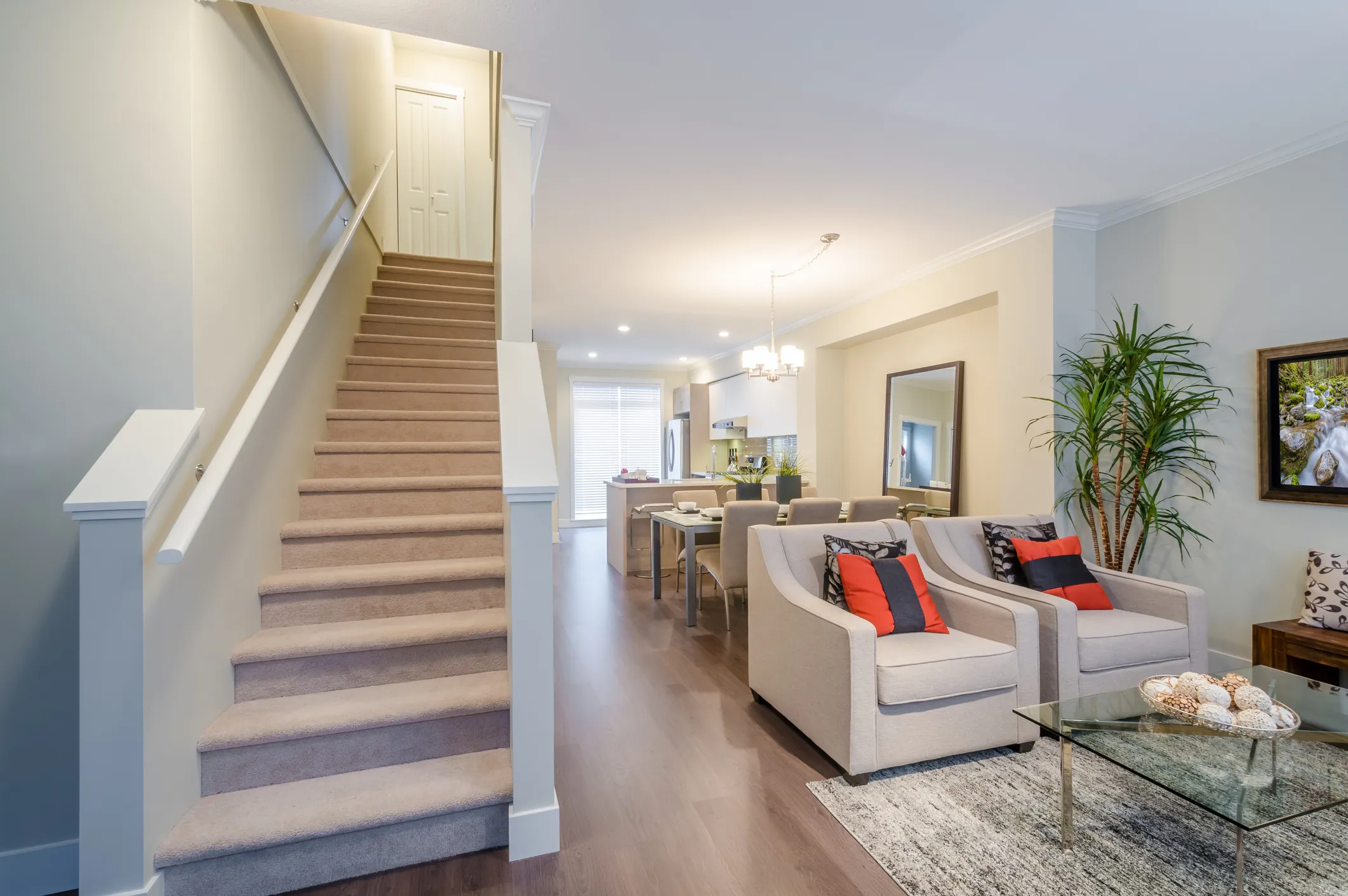 Staircase and landing in a neutral painted interior with wood flooring