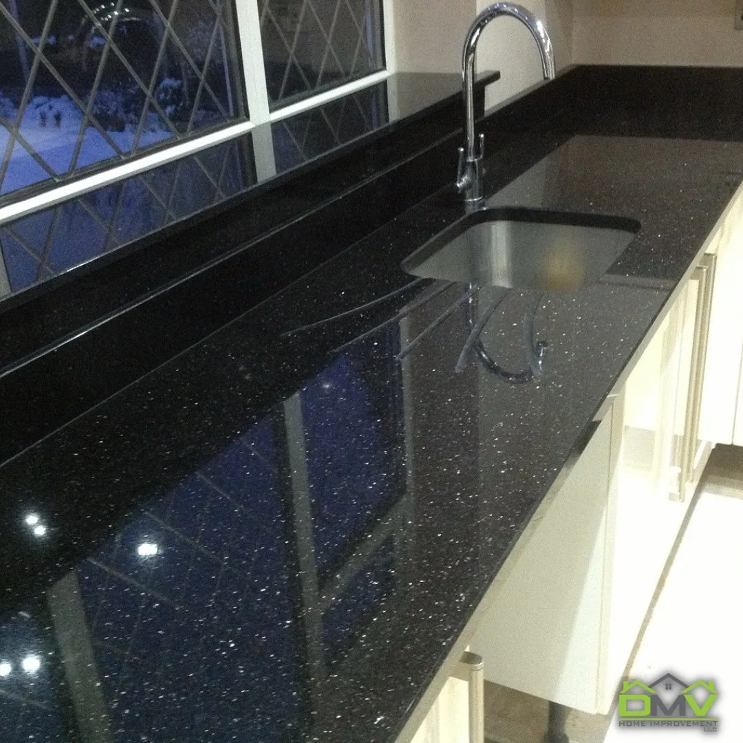 Black granite countertop with undermount sink and pull-down faucet