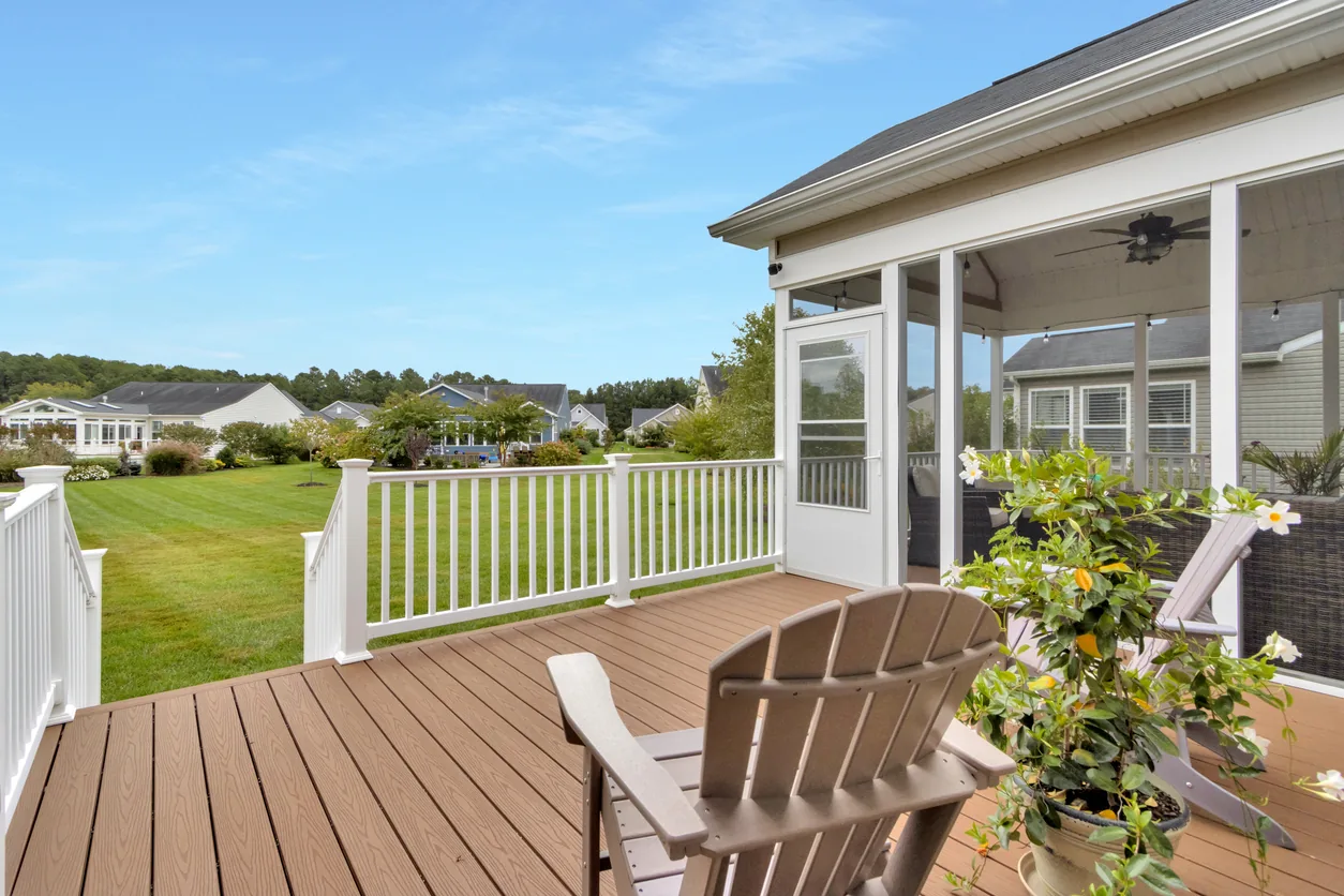 Composite deck with Adirondack chairs and neighborhood view