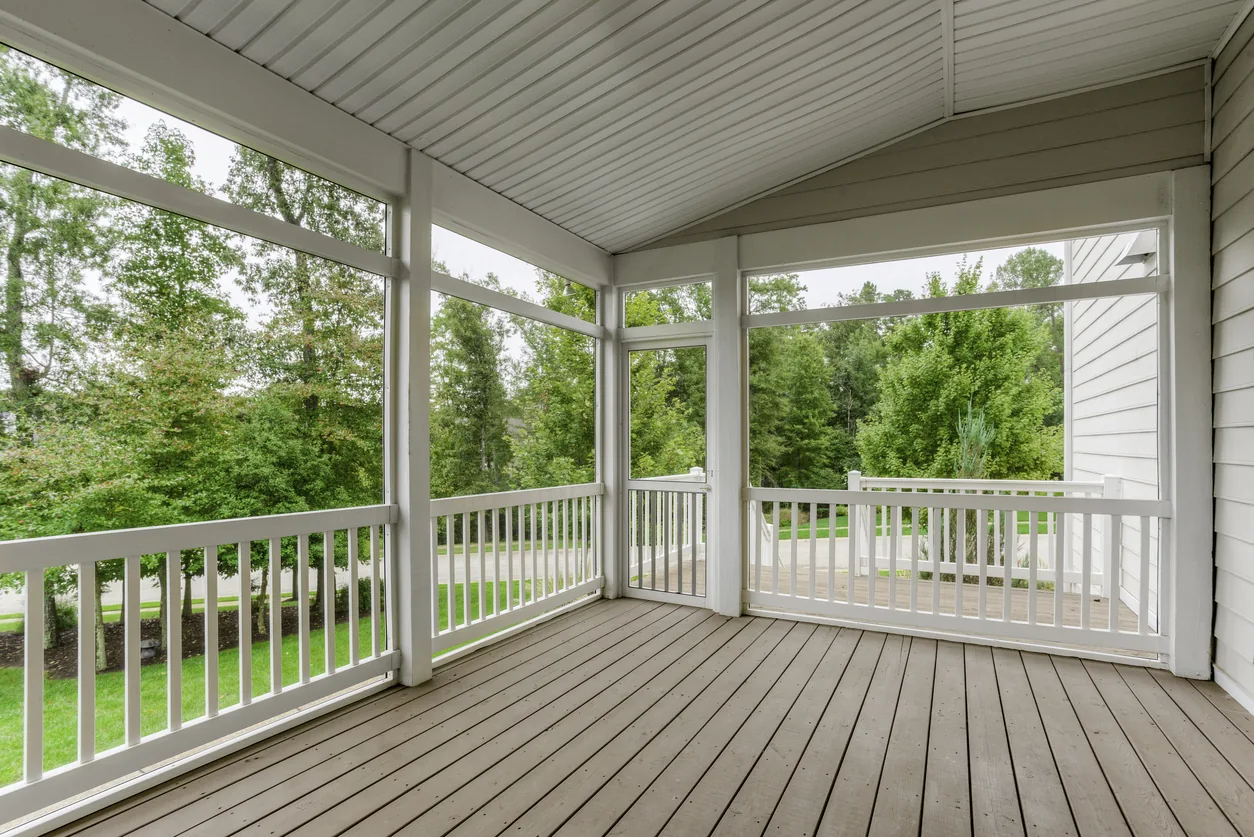 Covered screened porch with white railings and composite flooring