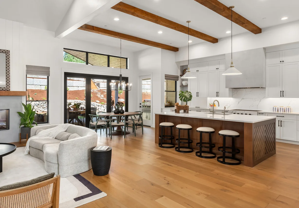 Open plan kitchen with beamed ceiling and island seating
